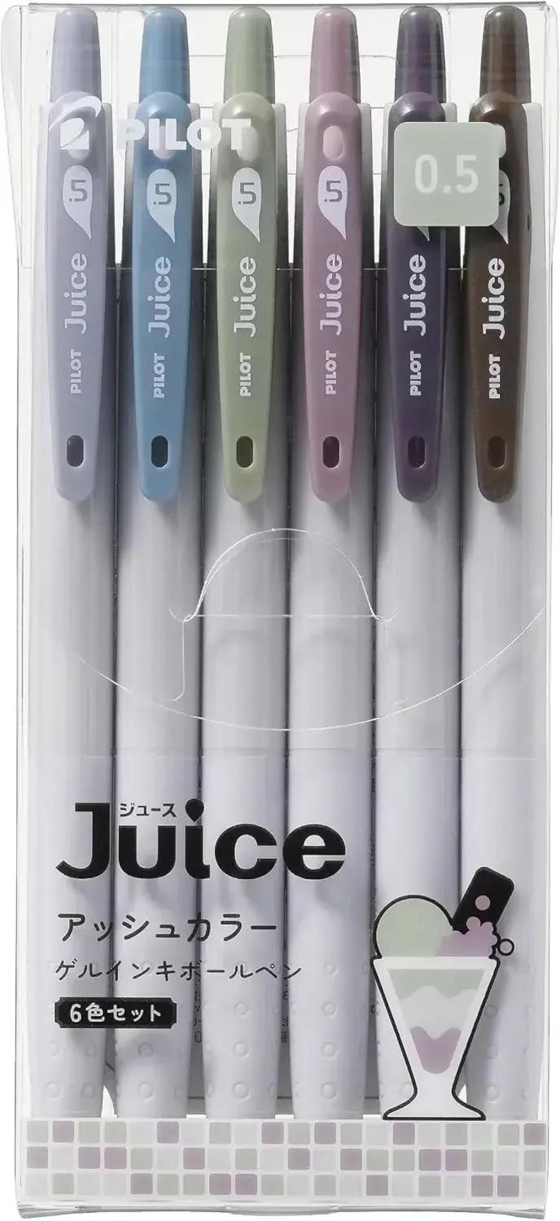 May include: A set of six Pilot Juice 0.5 gel ink pens in ash colors, packaged in a clear plastic case. The pens feature muted tones including gray, blue, green, mauve, purple, and brown, with the text Juice and Japanese characters visible.