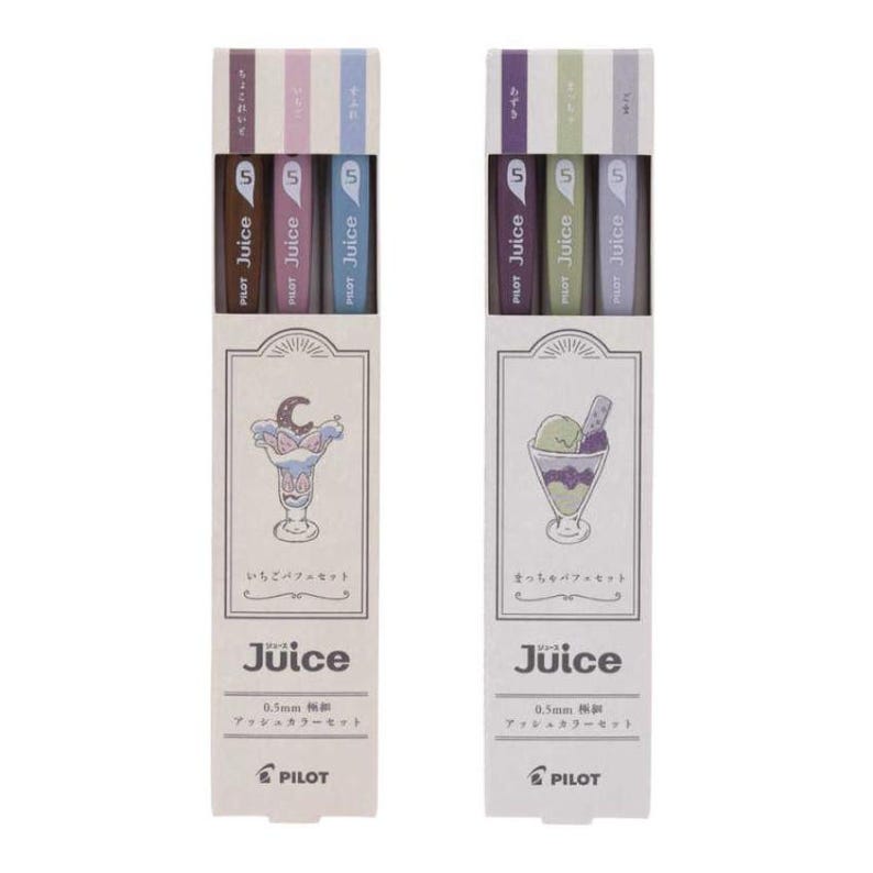 May include: Two sets of three Pilot Juice 0.5mm gel pens in rectangular cardboard packaging. The left set features a parfait illustration and brown, pink, and blue pens. The right set features a sundae illustration and purple, green, and grey pens.