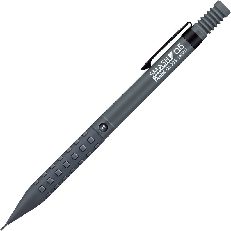 May include: A dark gray mechanical pencil with the text "SMASH 0.5" and "Pentel Q1005 JAPAN". The pencil has a textured grip, a black clip, and a ribbed eraser cap. The pencil is labeled "HB".