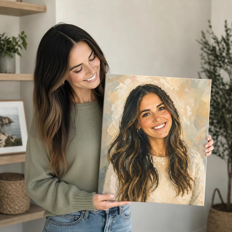 A woman is holding a painting of a smiling woman with long, wavy hair.