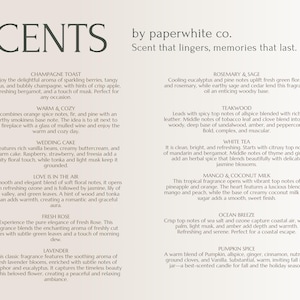 May include: A white card with a list of candle scents and descriptions. The scents include Champagne Toast, Warm & Cozy, Wedding Cake, Love is in the Air, Fresh Rose, Lavender, Rosemary & Sage, Teakwood, White Tea, Mango & Coconut Milk, Ocean Breeze, and Pumpkin Spice.
