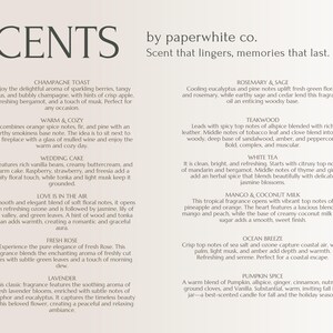 May include: A white card with a list of candle scents and descriptions. The scents include Champagne Toast, Warm & Cozy, Wedding Cake, Love is in the Air, Fresh Rose, Lavender, Rosemary & Sage, Teakwood, White Tea, Mango & Coconut Milk, Ocean Breeze, and Pumpkin Spice.