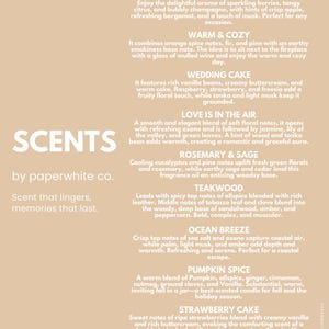 May include: A light tan informational sign titled SCENTS by paperwhite co. listing eight fragrance descriptions including Champagne Toast, Warm & Cozy, Wedding Cake, Love Is In The Air, Rosemary & Sage, Teakwood, Ocean Breeze, Pumpkin Spice, and Strawberry Cake.