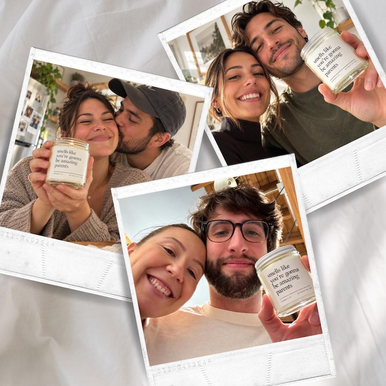 May include: A clear glass candle jar with a white label featuring the black text 'smells like you're gonna be amazing parents'. The candle is shown in three separate photographs, each featuring a couple holding the candle in their hands.