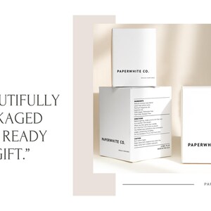 May include: Three white boxes with the text "PAPERWHITE CO." on them. The boxes are stacked on top of each other. The top box has the text "SOY WAX CANDLES" on it. The middle box has the text "BRUSHED GOLD" on it. The bottom box has the text "SOY WAX CANDLES" on it. The text "BEAUTIFULLY PACKAGED AND READY TO GIFT." is written in black text on a white background.