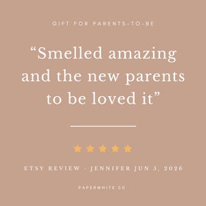 May include: A square graphic with a dusty rose background featuring the text GIFT FOR PARENTS-TO-BE, followed by the quote Smelled amazing and the new parents to be loved it, five yellow stars, and the text ETSY REVIEW JENNIFER JUN 5, 2026 PAPERWHITE CO.