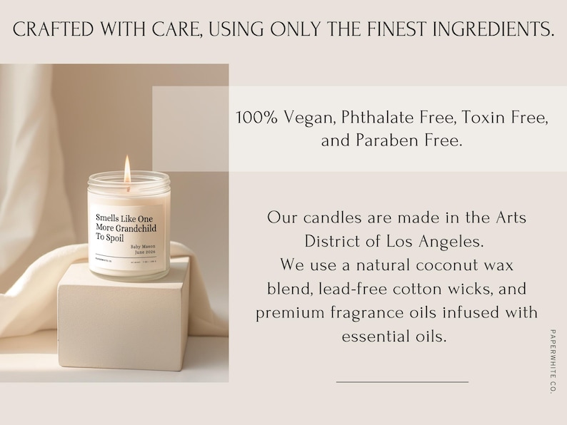May include: A lit candle in a clear glass jar with the text "Smells Like One More Grandchild To Spoil" on a white label. The candle sits on a white block. The image includes text stating the candle is vegan, phthalate, toxin, and paraben free.
