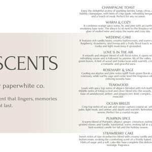 May include: A beige and white poster with the text "SCENTS by paperwhite co." and a list of different scents with descriptions. The scents include Champagne Toast, Warm & Cozy, Wedding Cake, Love is in the Air, Rosemary & Sage, Teakwood, Ocean Breeze, Pumpkin Spice, and Strawberry Cake.