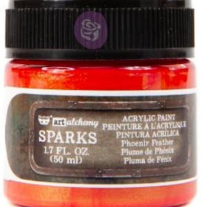 May include: A jar of Art Alchemy Sparks acrylic paint in the colour Phoenix Feather. The jar has a black ribbed lid and a label with the text Sparks, 1.7 fl. oz. (50 ml), and Phoenix Feather. The paint inside the clear glass jar is a vibrant red-orange.