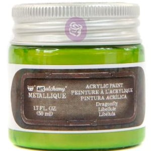May include: A small glass jar of bright green Art Alchemy Metallique acrylic paint with a silver screw-top lid. The label features the text '1.7 FL. OZ. (50 ml)', 'ACRYLIC PAINT', and the colour name 'Dragonfly' in a dark brown rectangular frame.