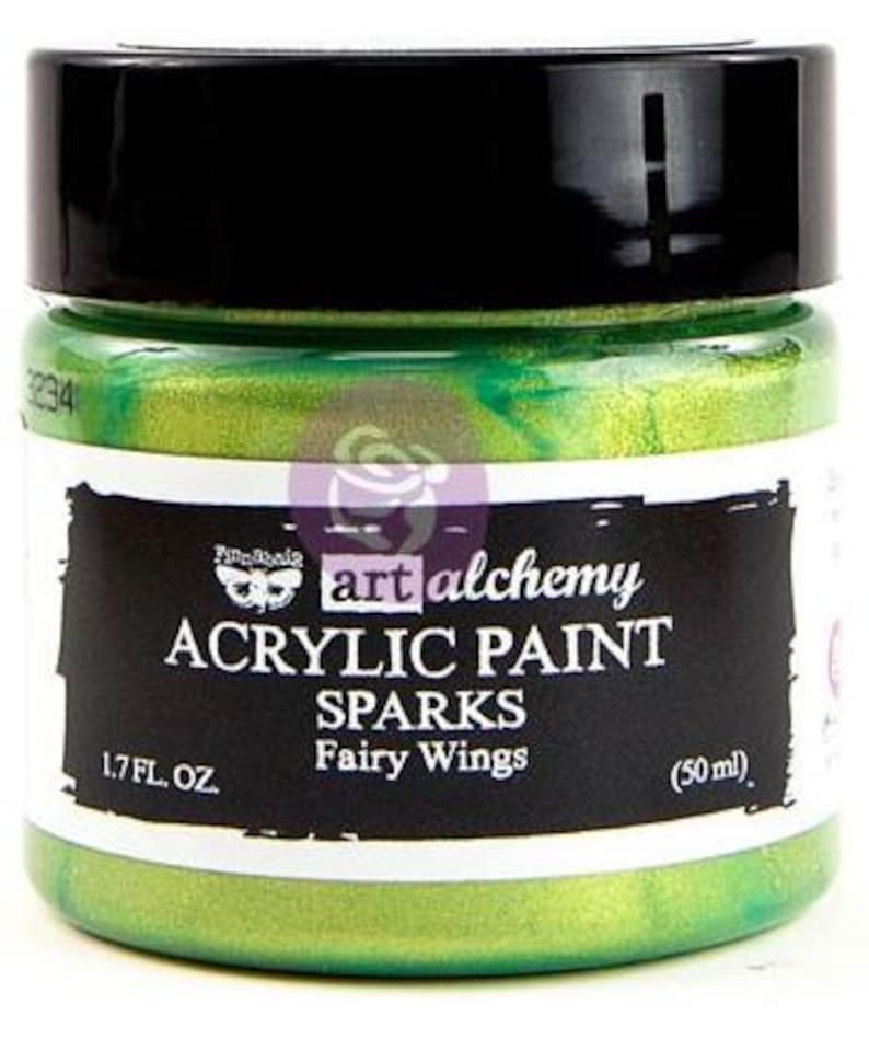 May include: A jar of bright green acrylic paint with a black lid. The label reads Art Alchemy Acrylic Paint Sparks Fairy Wings, 50 ml. The paint inside the clear jar is a vibrant, shimmering lime green colour with a metallic, reflective finish.
