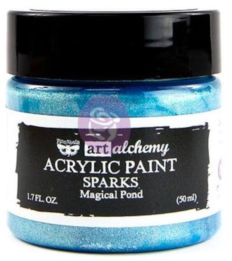 May include: A jar of Art Alchemy Sparks acrylic paint in the colour Magical Pond. The jar has a black lid and a white label with black text reading Art Alchemy Acrylic Paint Sparks Magical Pond 1.7 fl. oz. (50 ml) and a moth logo.