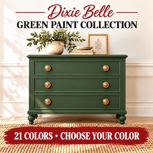 May include: A dark green three-drawer dresser with round gold knobs. Text reads: Dixie Belle GREEN PAINT COLLECTION and 21 COLORS • CHOOSE YOUR COLOR. The dresser is topped with a ceramic vase, green foliage, and a framed print.