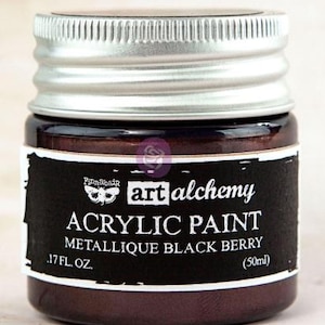 May include: A small jar of Finnabair Art Alchemy acrylic paint in the colour Metallique Black Berry. The jar features a silver screw-top lid and a black label with white text reading Art Alchemy, Acrylic Paint, Metallique Black Berry, 50ml.