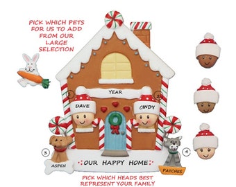 May include: A gingerbread house Christmas ornament with customizable faces and pets. The ornament features a gingerbread house with candy cane accents, a blue door, and a wreath. The text "Our Happy Home" is printed on the ornament.  The ornament comes with a variety of faces and pets to choose from, including a dog, a wolf, a rabbit, and a variety of people.