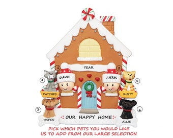 May include: A gingerbread house Christmas ornament with a candy cane roof and two people peeking out the windows. The ornament has the text "YEAR" above the house and "OUR HAPPY HOME" below the house. There are also four pets on the ornament, with their names written below them.