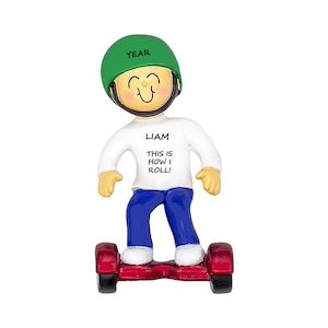 May include: A figurine of a person on a red hoverboard, wearing a green helmet with the word "YEAR" and a white shirt with the name "LIAM" and the phrase "THIS IS HOW I ROLL!" in black text. The person is wearing blue pants.
