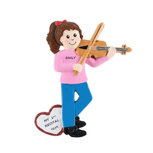 May include: Personalized Christmas ornament featuring a girl playing a violin. The ornament is decorated with a pink shirt, blue jeans, and a red bow. The text "Emily" and "My 1st Recital Year" is included on the ornament.