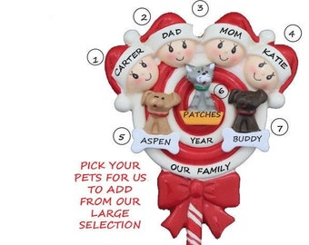 May include: A red and white candy cane ornament with a bow on top. The ornament features a family of four with their pets. The names Carter, Dad, Mom, and Katie are written on the ornament. The pets are named Aspen, Patches, and Buddy. The text "Pick your pets for us to add from our large selection" is written on the ornament.