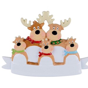 May include: A Christmas ornament featuring a family of five reindeer. The reindeer have brown bodies, large black eyes, and wear colorful scarves. The ornament has a white banner at the bottom.