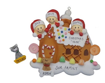 May include: A gingerbread house Christmas ornament with four people peeking out of the windows. The house is decorated with candy canes, gumdrops, and sprinkles. The ornament also includes a dog and a cat. The text on the ornament reads "Our Family" and "Christmas *Year*".