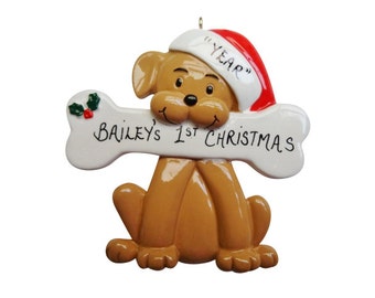 May include: A brown dog wearing a red Santa hat with the text "1st YEAR" on it, holding a white bone with the text "Bailey's 1st Christmas" in black.