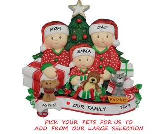 May include: A personalised Christmas bauble featuring a family of four in red and green pyjamas standing in front of a Christmas tree. The bauble includes the names "Mom", "Dad", "Emma", and "Patches" along with the text "Our Family".