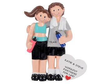 May include: Personalized Christmas ornament featuring a couple in workout attire, holding water bottles. The ornament includes the text "Katie & Steve Workout Partners for Life!"