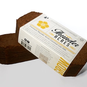 May include: Two brown compressed coconut coir bricks labeled "Thunder Acres Premium Coconut Coir Pith". The label is white with black text and a yellow flower graphic. The text on the label reads "Thunder Acres Coco Coir is 100 percent organic and a renewable alternative to peat moss. Made from coconut husk, coco coir is perfect for organic or hydro-organic growing applications. Thunder Acres Coco Coir is also an excellent addition to seed starting and potting mixes."