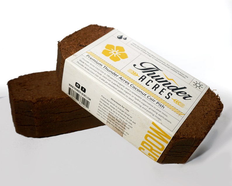 May include: Two brown compressed coconut coir bricks labeled "Thunder Acres Premium Coconut Coir Pith". The label is white with black text and a yellow flower graphic. The text on the label reads "Thunder Acres Coco Coir is 100 percent organic and a renewable alternative to peat moss. Made from coconut husk, coco coir is perfect for organic or hydro-organic growing applications. Thunder Acres Coco Coir is also an excellent addition to seed starting and potting mixes."