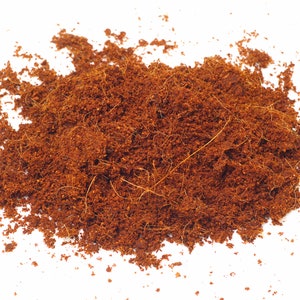 May include: A close-up of a pile of brown coconut coir, a natural fiber used for gardening and other purposes.