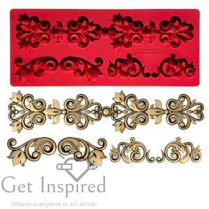 May include: Silicone mold with four different ornate designs for making cake decorations. The mold is red and the designs are in the shape of scrolls and leaves. The mold is shown with finished decorations in gold.
