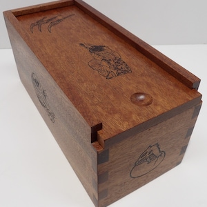 wooden box with wizards/dragons and sliding top.