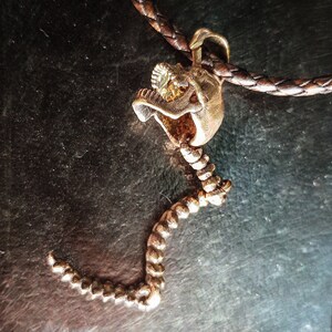 Skull Skeleton pendant with spine with 4 moving parts.