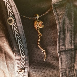 Skull Skeleton pendant with spine with 4 moving parts.