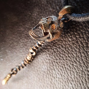 Skull Skeleton pendant with spine with 4 moving parts.