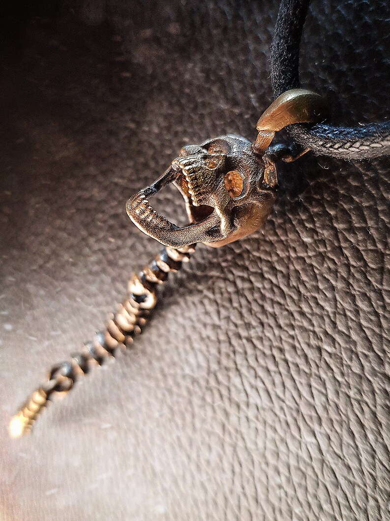 Skull Skeleton pendant with spine with 4 moving parts.