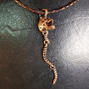 Skull Skeleton pendant with spine with 4 moving parts.