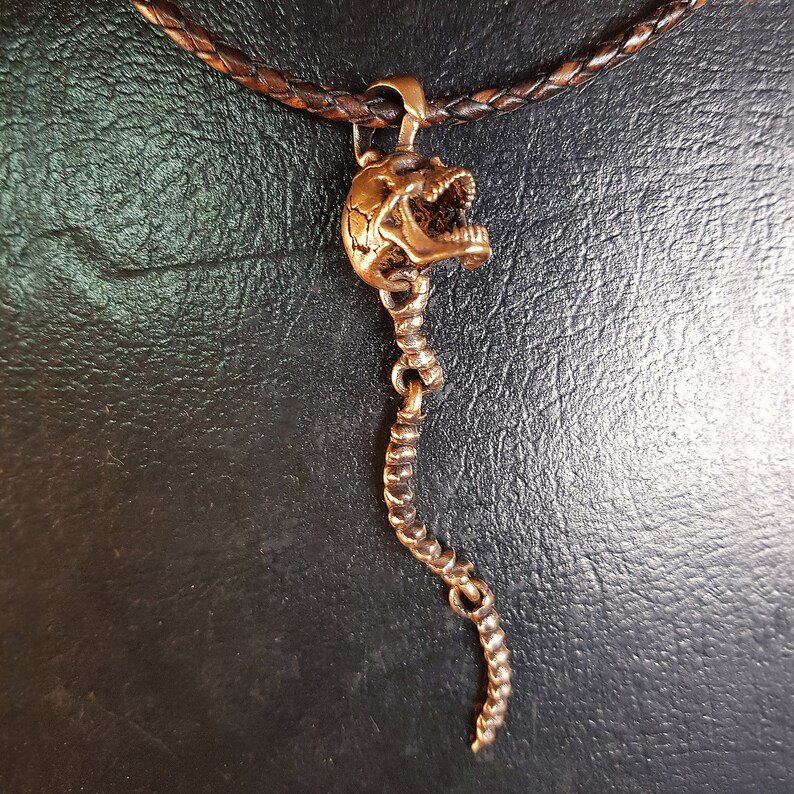 Skull Skeleton pendant with spine with 4 moving parts.