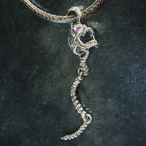 Skull Skeleton pendant with spine with 4 moving parts.