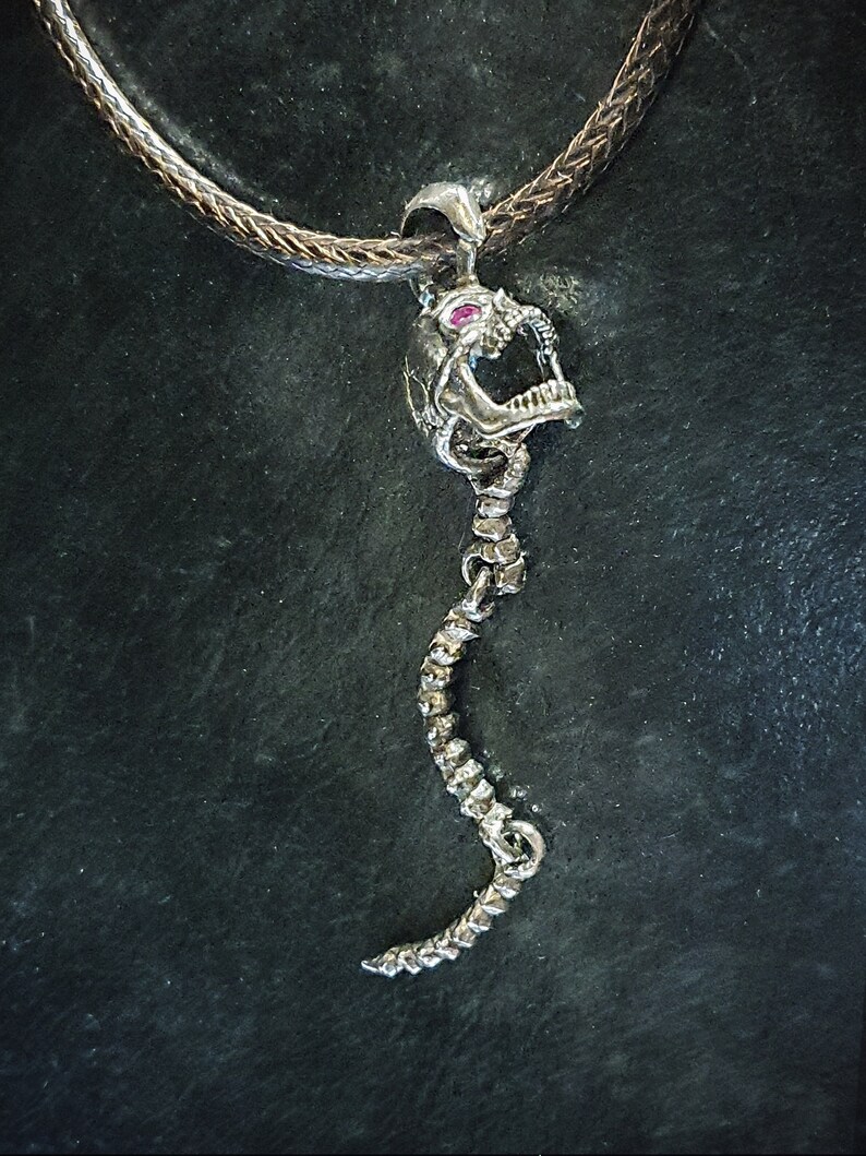 Skull Skeleton pendant with spine with 4 moving parts.