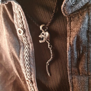 Skull Skeleton pendant with spine with 4 moving parts.