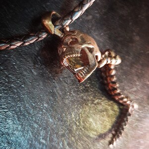 Skull Skeleton pendant with spine with 4 moving parts.