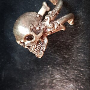 Decorative adjustable Cross bone skull Ring.