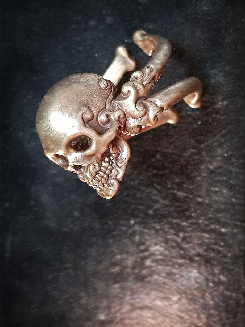 Decorative adjustable Cross bone skull Ring.