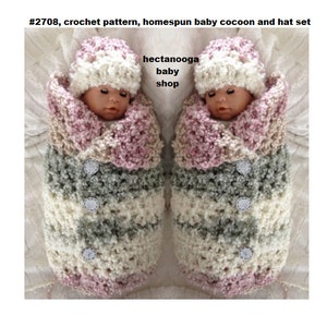 May include: A crochet pattern for a baby cocoon and hat set. The set is made in a pink, white and grey colour scheme. The cocoon is a long, cylindrical shape with a hood. The hat is a simple beanie style. The pattern is available for purchase on Etsy.