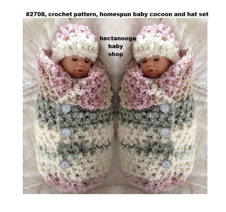 May include: A crochet pattern for a baby cocoon and hat set. The set is made in a pink, white and grey colour scheme. The cocoon is a long, cylindrical shape with a hood. The hat is a simple beanie style. The pattern is available for purchase on Etsy.