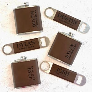 May include: Four personalized brown leather flask sets with a matching bottle opener. Each set features a different name, including "Dustin", "Dylan", and "Josh".