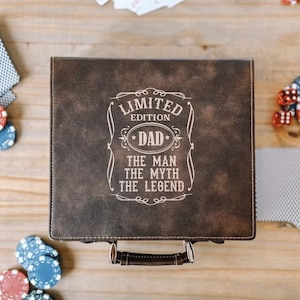 May include: A brown leather box with a handle. The box has a white inscription that reads "Limited Edition Dad The Man The Myth The Legend".