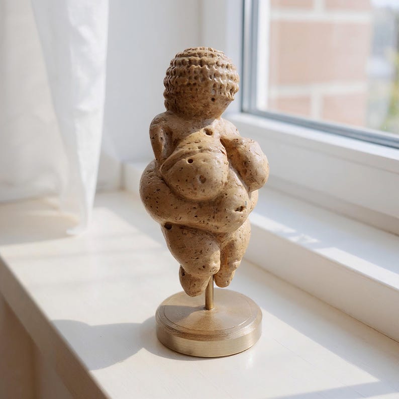 Venus of Willendorf replica in collector display, museum-style lighting